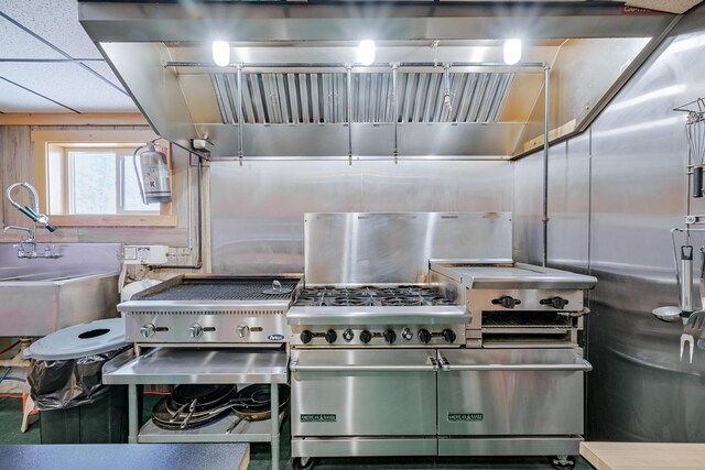 kitchen featuring a drop ceiling and a sink