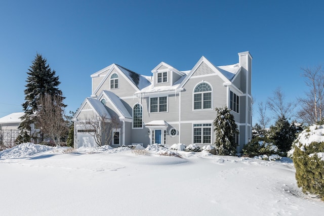 shingle-style home featuring a chimney