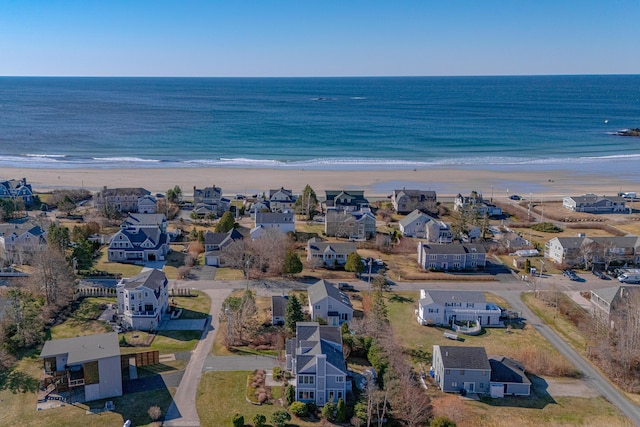 drone / aerial view featuring a beach view, a residential view, and a water view