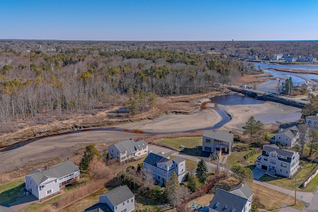 aerial view featuring a view of trees and a water view