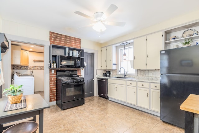 kitchen with tasteful backsplash, black appliances, washing machine and dryer, open shelves, and a sink