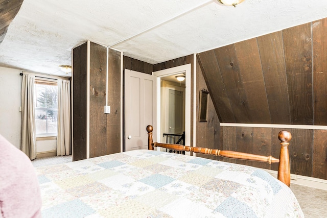 bedroom with carpet floors and wooden walls