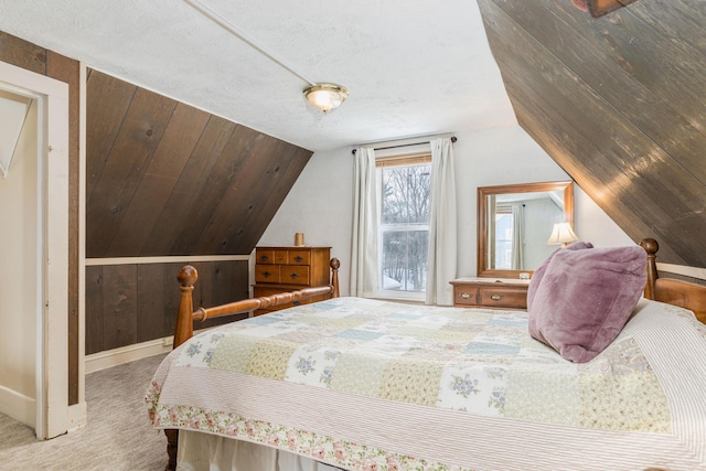 bedroom featuring vaulted ceiling, carpet, and baseboards