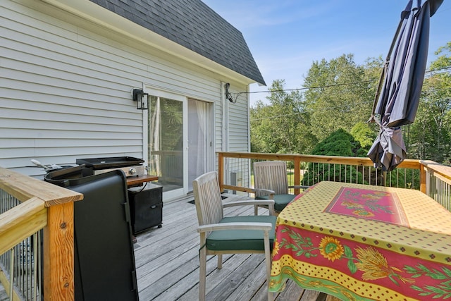 wooden deck with outdoor dining area