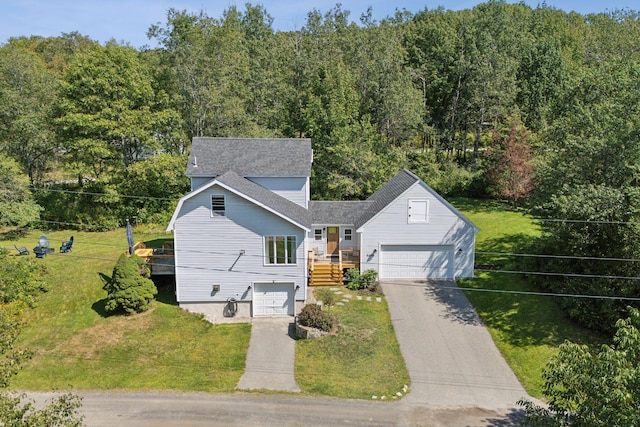 view of front facade featuring a garage, a front yard, concrete driveway, and a shingled roof