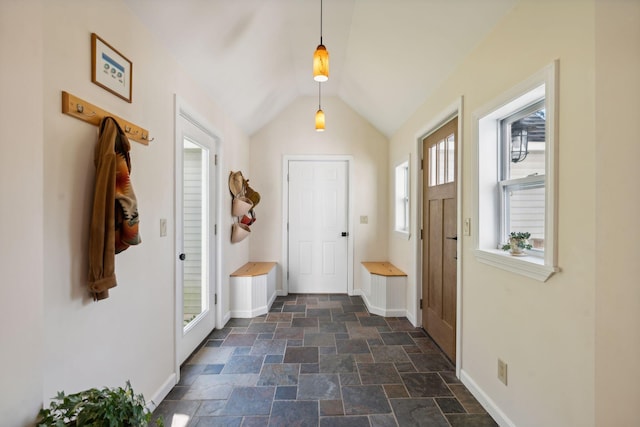 mudroom featuring stone finish floor, vaulted ceiling, and baseboards