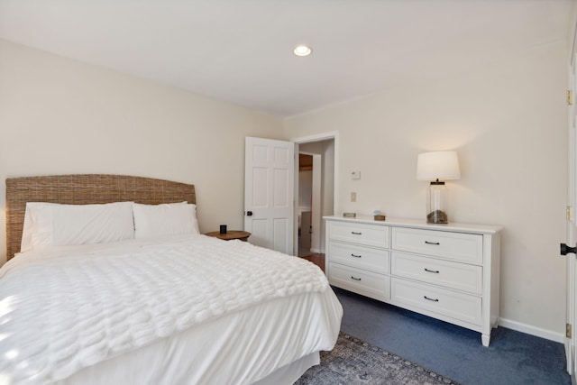 bedroom with baseboards and dark carpet