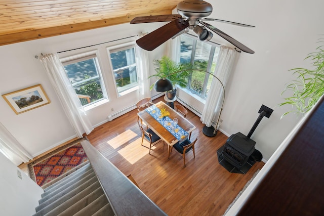 living area with a healthy amount of sunlight, baseboards, and wood finished floors