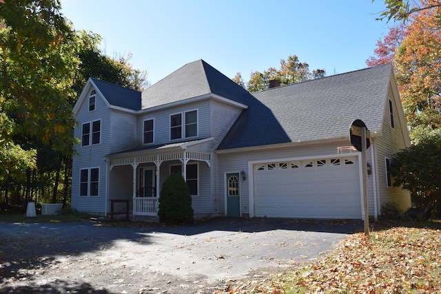 view of front of home featuring a garage, covered porch, roof with shingles, and a chimney