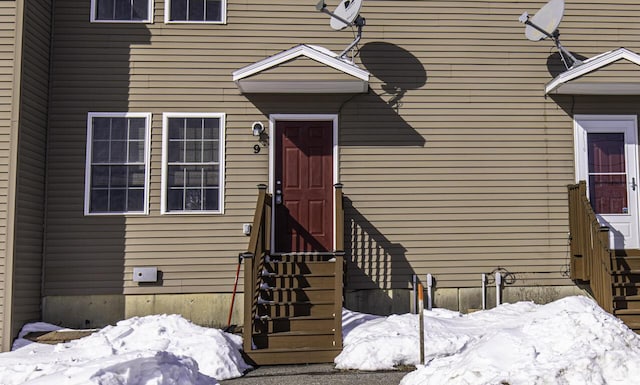 view of snow covered property entrance