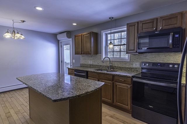 kitchen with black dishwasher, a center island, light wood-type flooring, stainless steel range with electric stovetop, and a sink