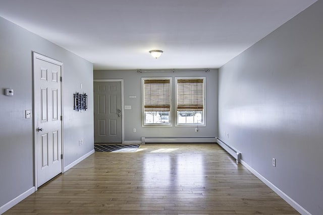 entryway featuring baseboards and wood finished floors