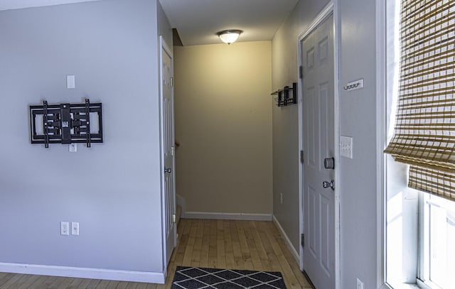 hallway with baseboards and light wood-style floors