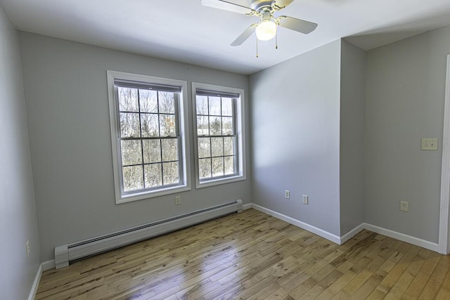 unfurnished room featuring light wood-style floors, a baseboard radiator, baseboards, and a ceiling fan