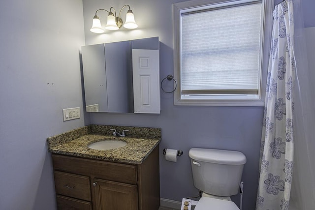 bathroom featuring toilet and vanity