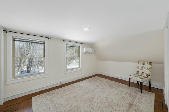 bonus room featuring baseboards, vaulted ceiling, dark wood finished floors, and a wall mounted air conditioner