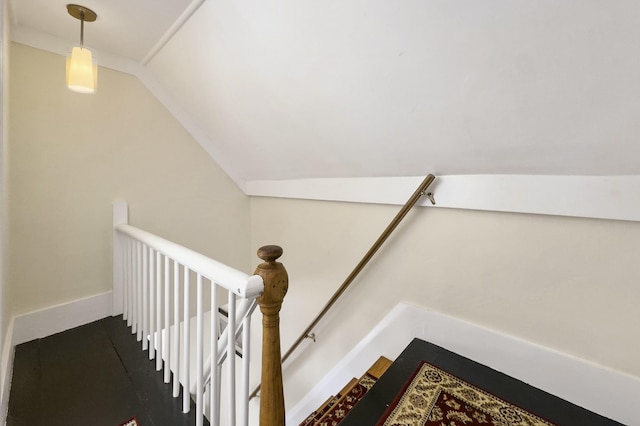 stairs featuring lofted ceiling and baseboards