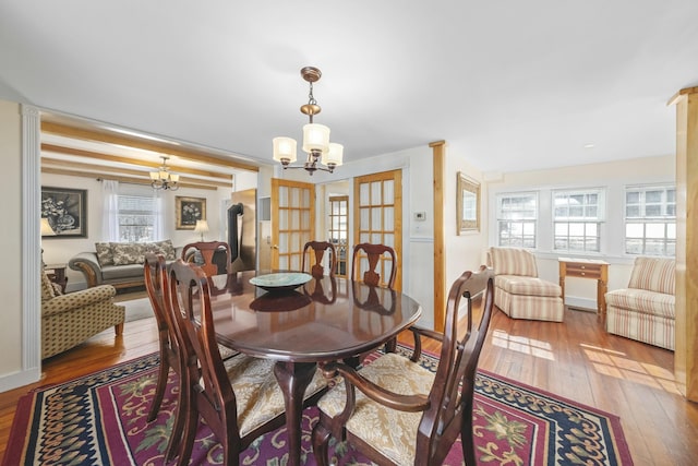 dining area featuring a notable chandelier and wood finished floors