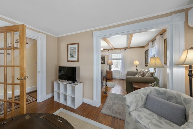 living area with baseboards, beamed ceiling, wood finished floors, and ornamental molding