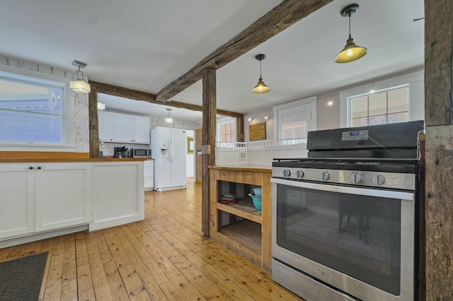 kitchen with white cabinets, appliances with stainless steel finishes, light wood finished floors, beamed ceiling, and decorative light fixtures