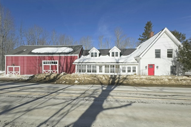 view of front facade featuring an outbuilding and a barn