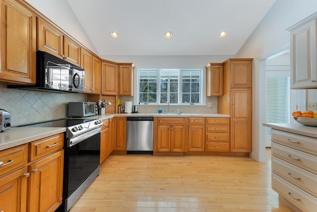 23 Sunny Acres Ln, Boothbay, ME 04537 - kitchen with appliances with stainless steel finishes, vaulted ceiling, a sink, tasteful backsplash, and light countertops