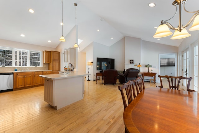 23 Sunny Acres Ln, Boothbay, ME 04537 - kitchen featuring stainless steel dishwasher, a sink, light countertops, pendant lighting, and high vaulted ceiling