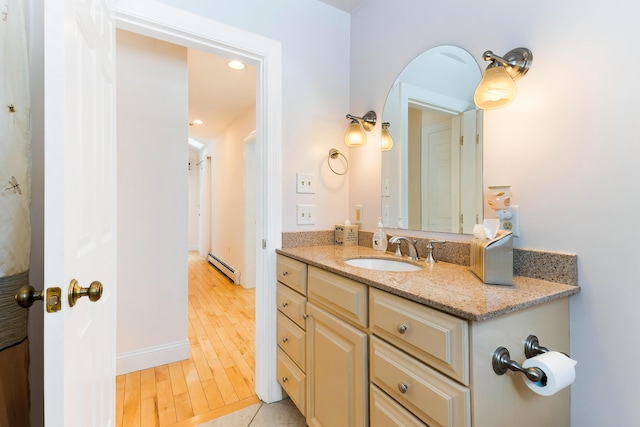 23 Sunny Acres Ln, Boothbay, ME 04537 - bathroom featuring a baseboard heating unit, wood finished floors, vanity, recessed lighting, and baseboards