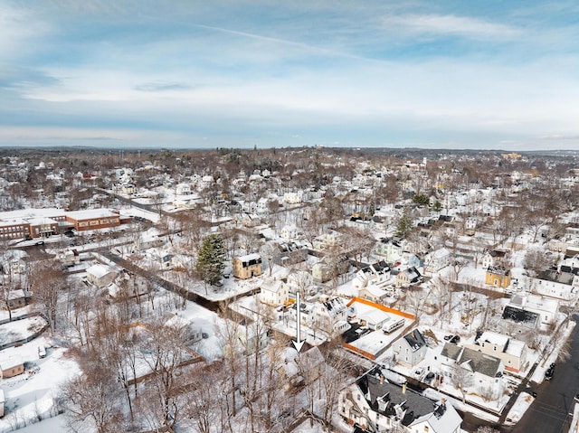 snowy aerial view with a residential view