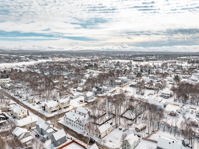 snowy aerial view with a residential view