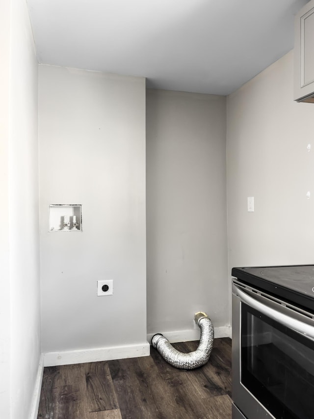 laundry room featuring dark wood-type flooring, laundry area, electric dryer hookup, and baseboards