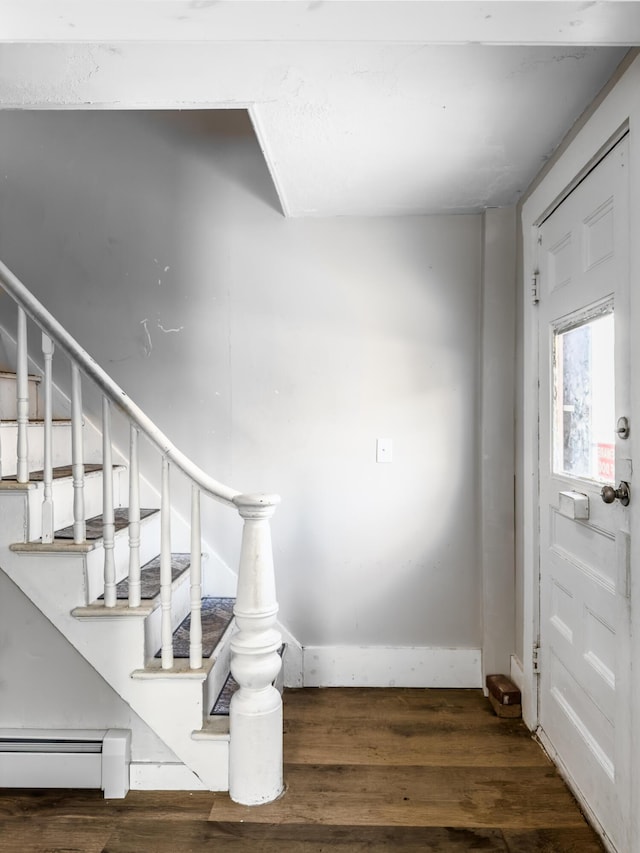 stairway featuring baseboards and wood finished floors