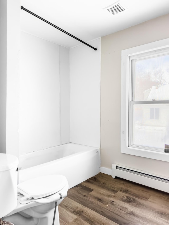 full bathroom featuring shower / bathtub combination, a baseboard radiator, toilet, wood finished floors, and visible vents