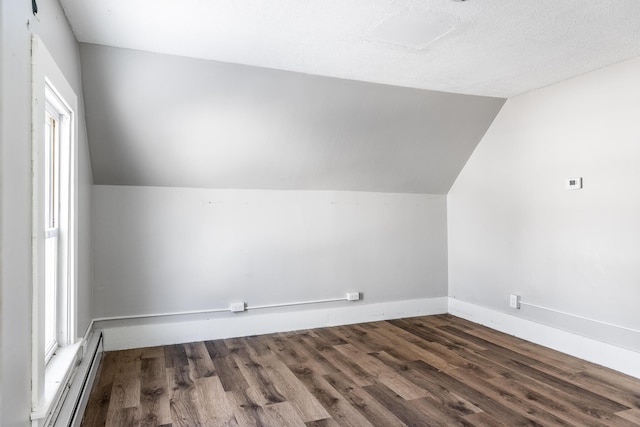 bonus room with lofted ceiling, a baseboard radiator, baseboards, and dark wood-style flooring