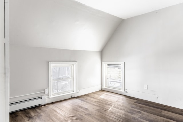 bonus room with plenty of natural light, wood finished floors, a baseboard radiator, and lofted ceiling