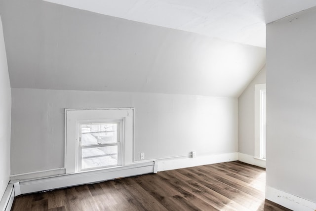 additional living space featuring lofted ceiling, baseboard heating, and wood finished floors