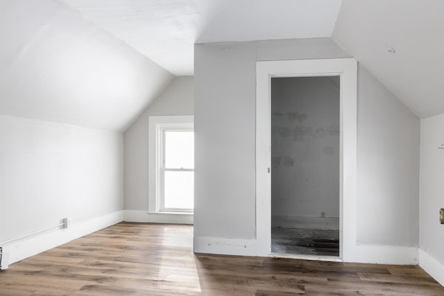 bonus room with vaulted ceiling and wood finished floors