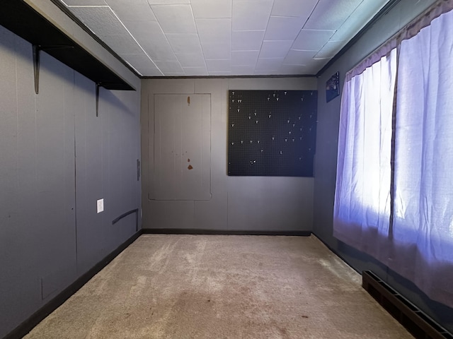 unfurnished room featuring a baseboard radiator and light colored carpet