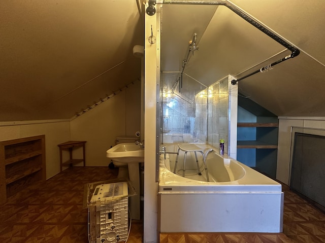 bonus room featuring built in shelves, lofted ceiling, and a sink