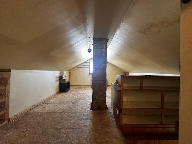 additional living space featuring lofted ceiling