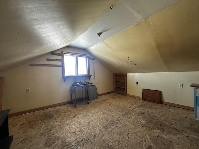 additional living space featuring lofted ceiling and baseboards