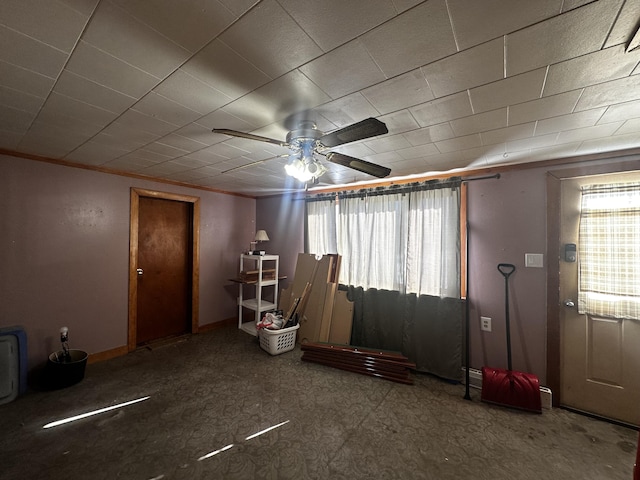 interior space featuring ceiling fan and baseboards