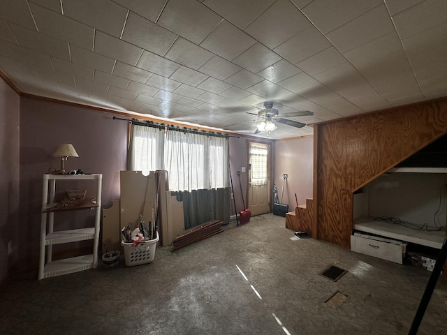 unfurnished living room with a ceiling fan and visible vents