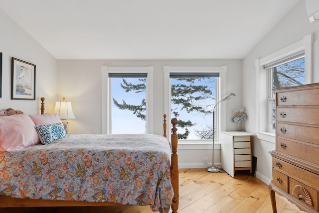 bedroom featuring light wood-style flooring and baseboards