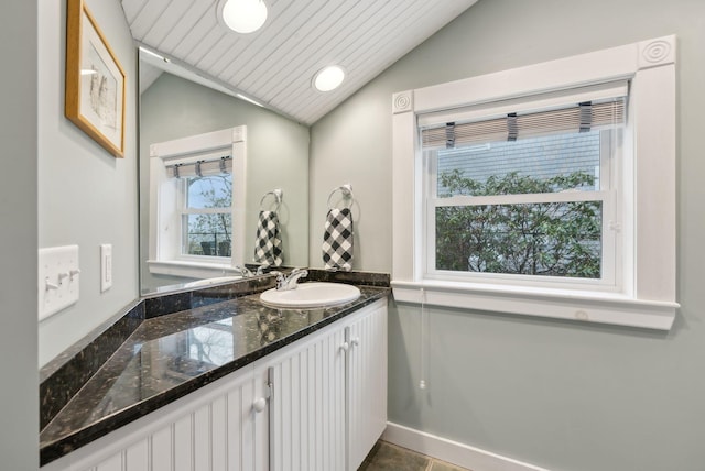 bathroom with lofted ceiling and vanity