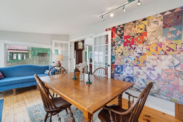dining space featuring wood-type flooring