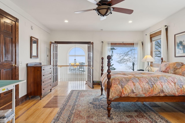 bedroom featuring multiple windows, recessed lighting, light wood finished floors, ceiling fan, and baseboards