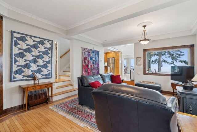 living area with light wood-type flooring, stairs, and ornamental molding