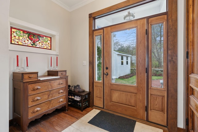 foyer featuring ornamental molding and dark wood-style floors