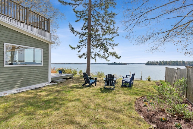 view of yard featuring a water view and a balcony